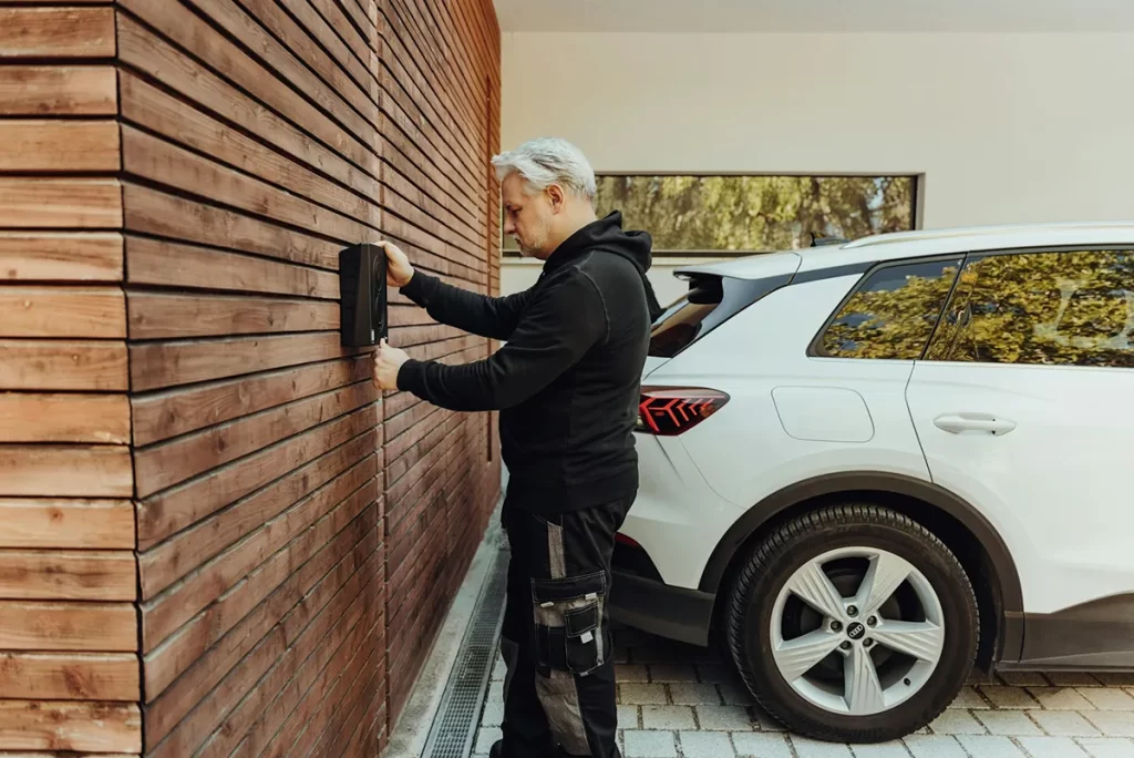Electrician installing an EV charger, showcasing the growing opportunities for electrician jobs in Edinburgh.