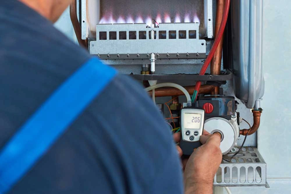 Gas engineer testing a boiler system, illustrating gas engineer jobs in East Kilbride.