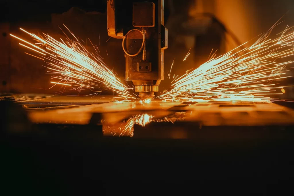 Metal cutting machine in action with sparks flying, demonstrating precision and efficiency for CNC's Jobs Glasgow.