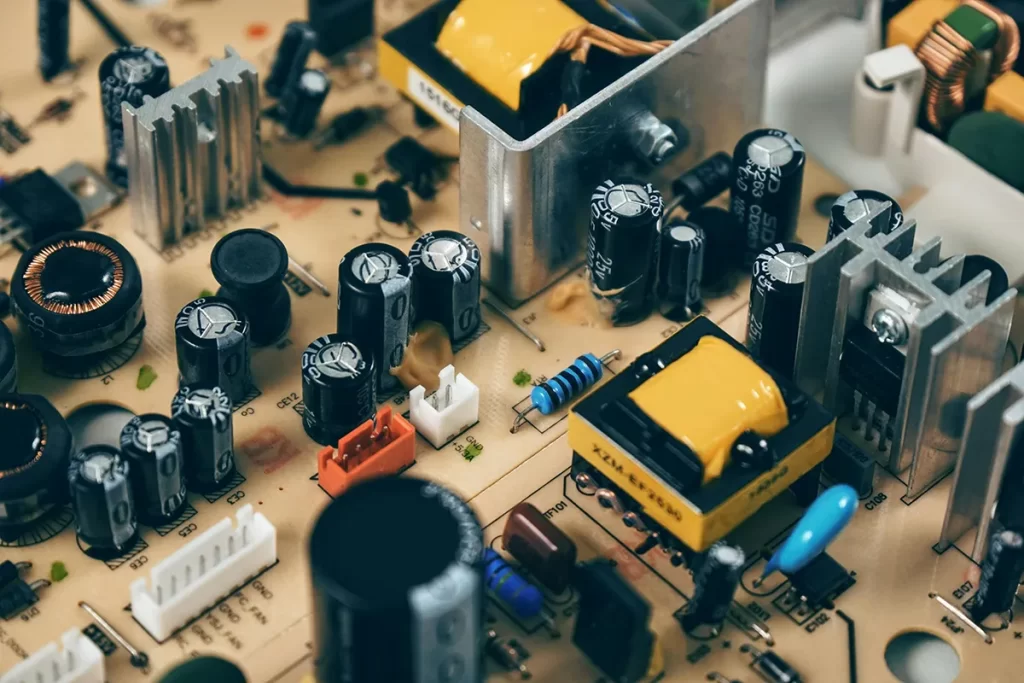 Close-up image of a green circuit board with intricate pathways and electronic components, symbolising technology and innovation related to electrical engineer jobs Hamilton.