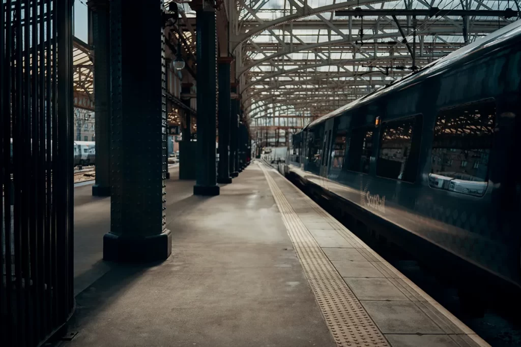 Modern passenger train at a Scottish train station platform, symbolising the transport industry’s demand for skilled professionals in Mechanical Fitter Jobs Scotland.