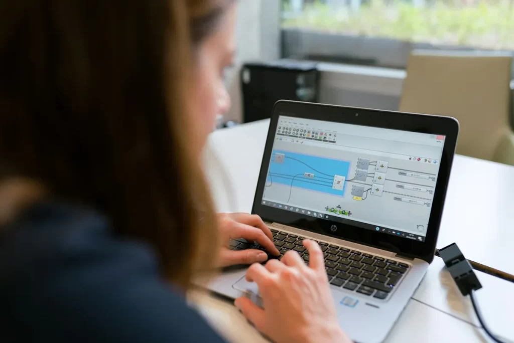 A person working on a laptop displaying electrical design software, illustrating skills relevant to Electrical Engineer jobs in the technology and engineering sectors.
